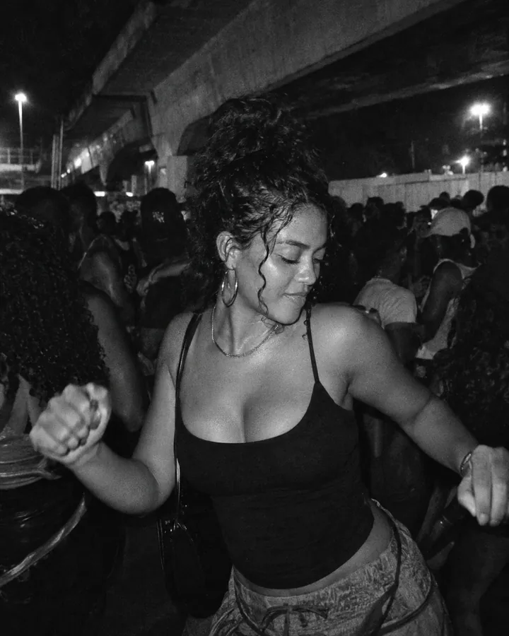 A black-and-white film still of a dancer in a night crowd